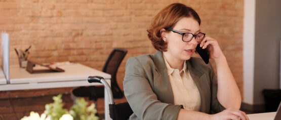 GlobalReach-photo-of-woman-talking-through-smartphone-while-using-laptop