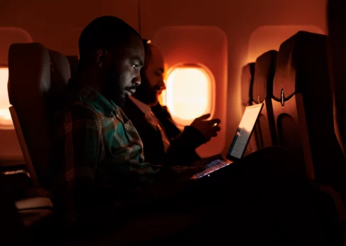 passenger on plane using inflight wi-fi by globalreach